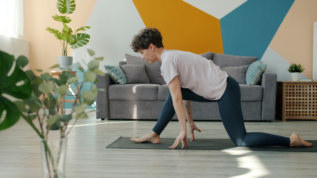 Woman doing yoga on a mat in a living room